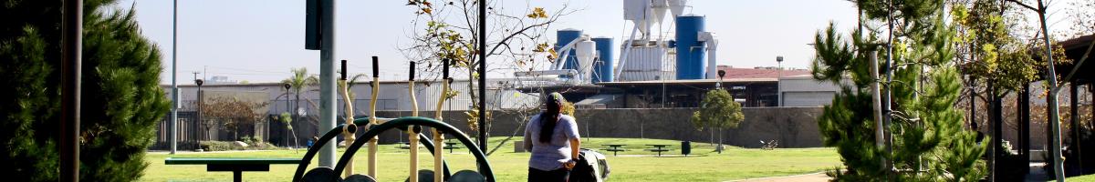 parent pushing a stroller on track at park in South Los Angeles