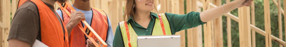 architect and construction workers at site