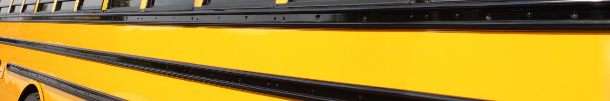 children on school bus waving out windows