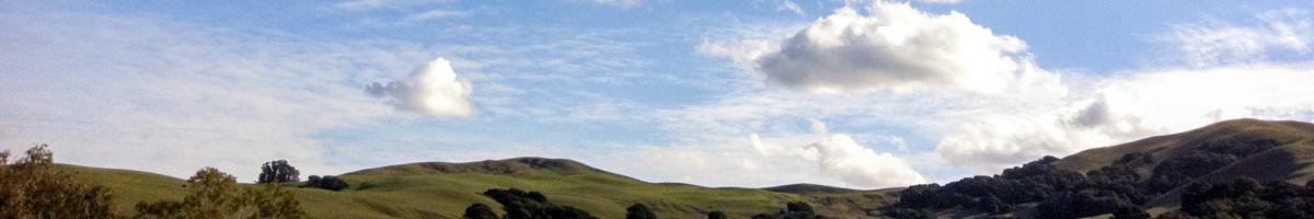 sky and clouds over rolling hills