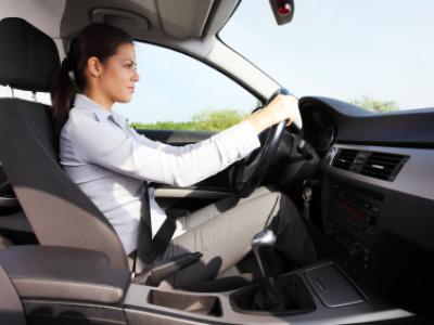 Photograph of woman driving a car