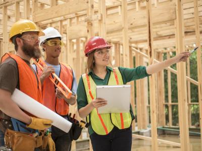 architect and construction workers at site